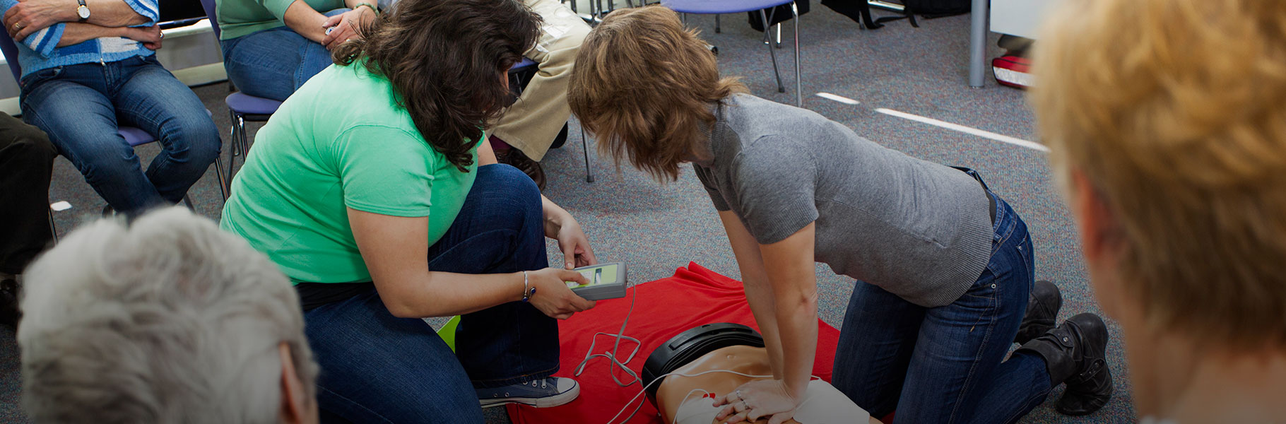 student learning cpr using cpr dummy