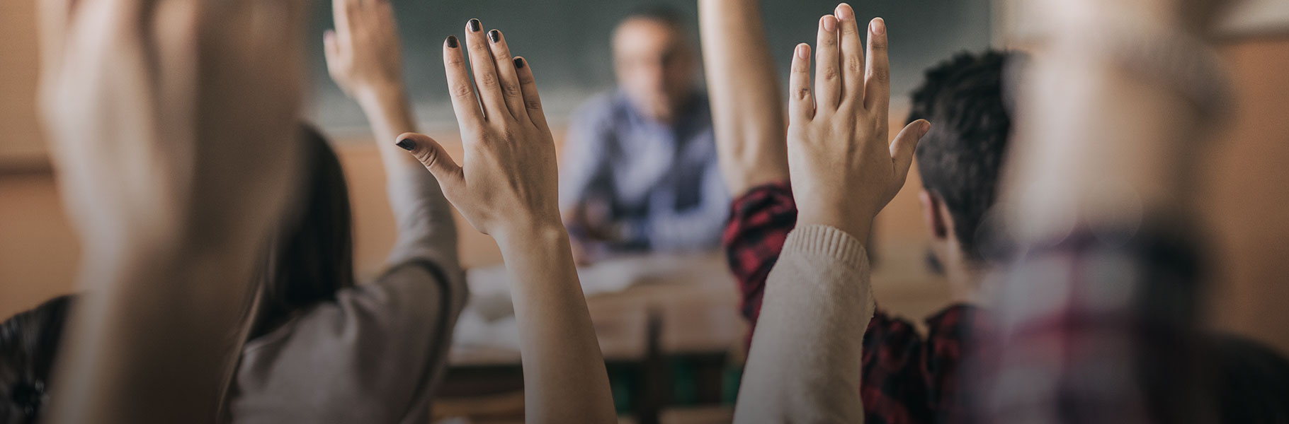 Hands in the air in classroom