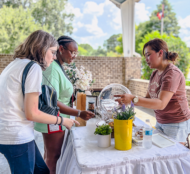 students serving food at table