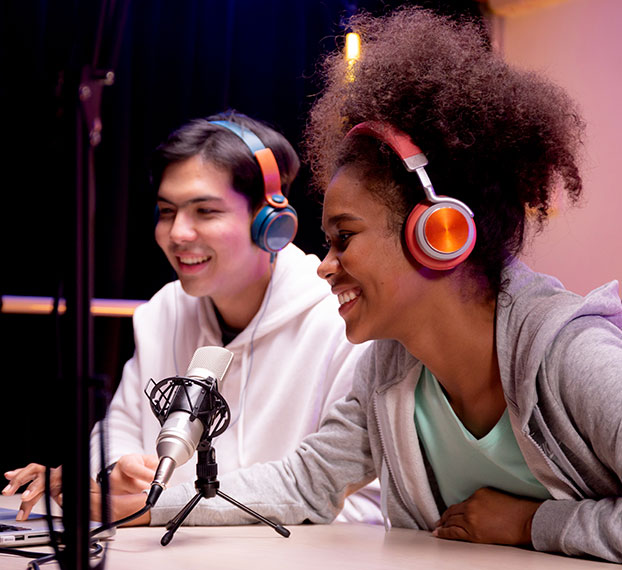 two students at recording microphone