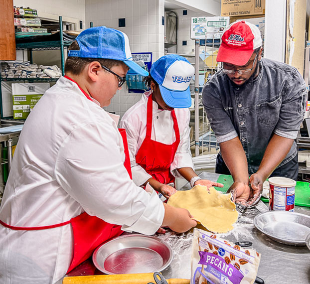 students working with chef on pastry