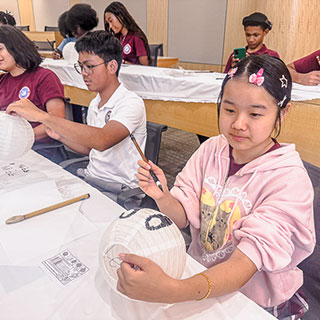 students working on lantern craft project in classroom