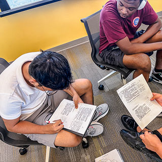 students reviewing work in group