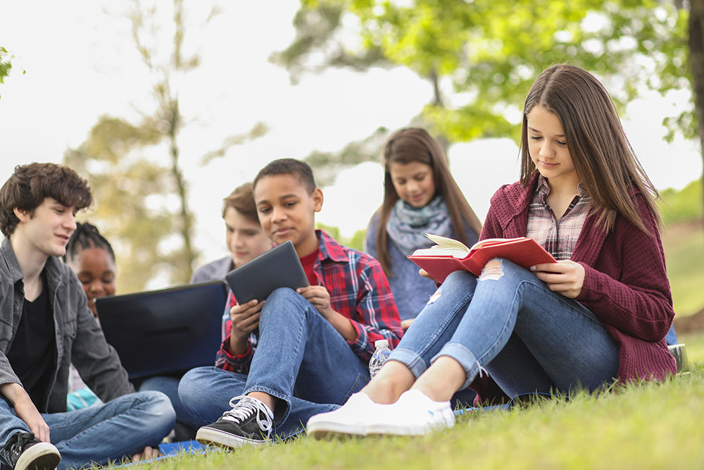 StarTalk students outdoors reading and talking